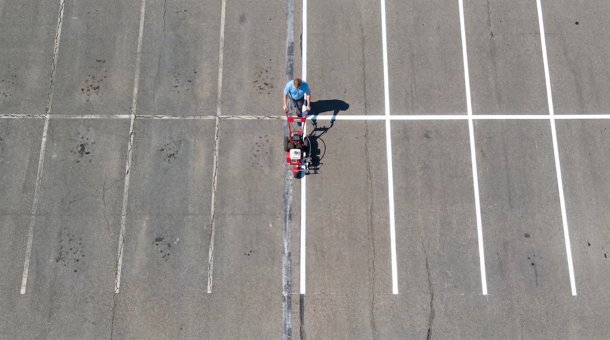 Aerial view of a parking lot being freshly restriped across the Triangle, NC